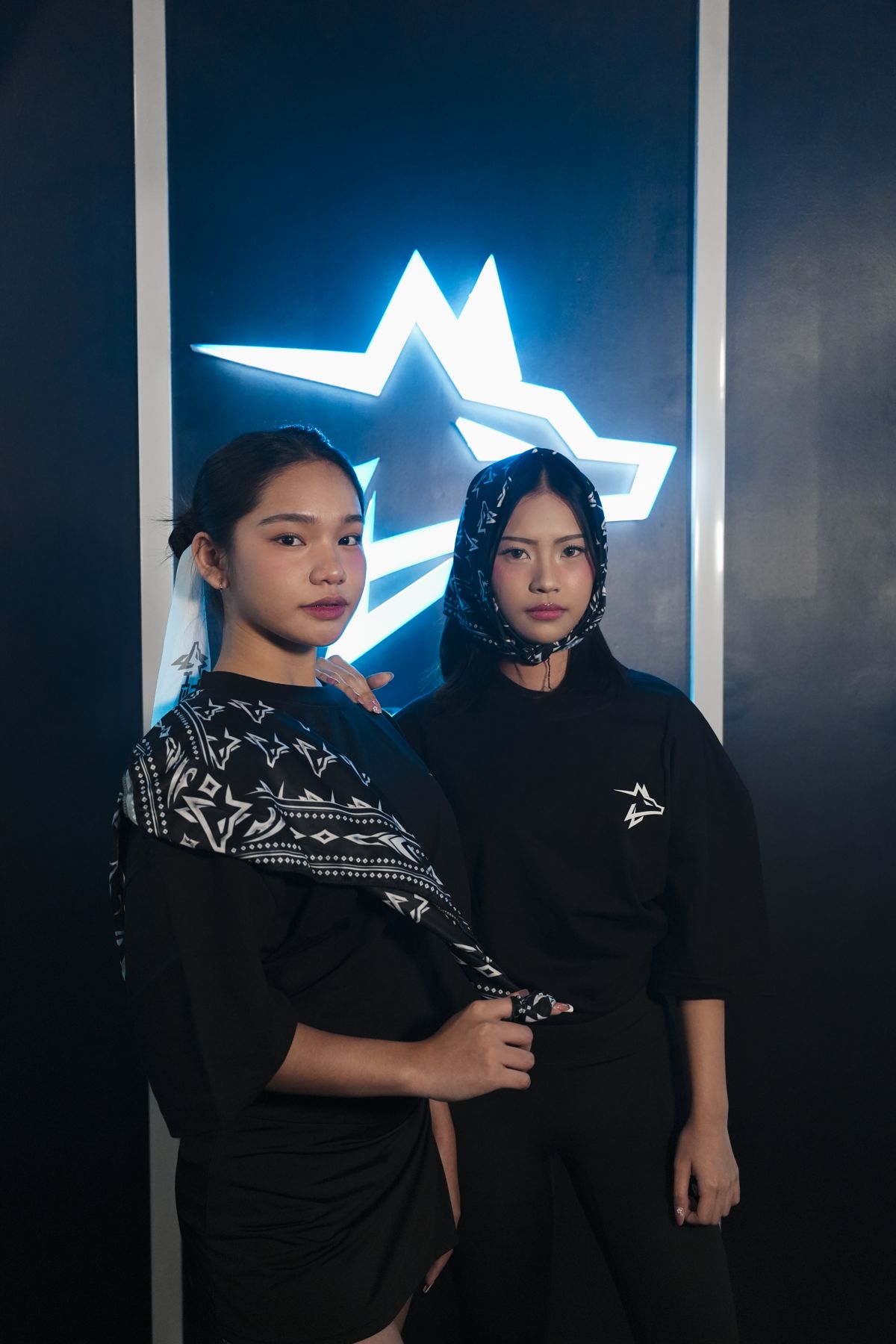 Two models in APX tees under the Apex neon